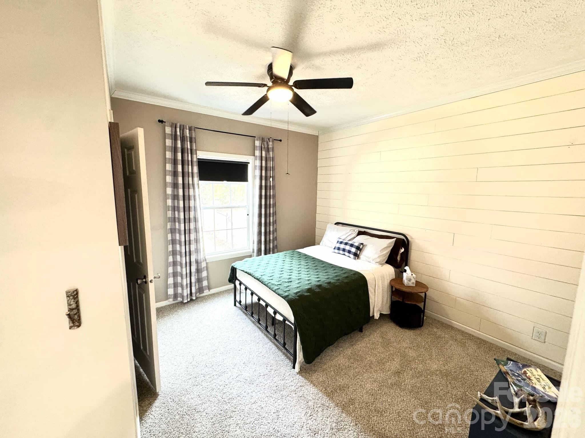 49428 Quail Trail Road Norwood, NC 28128 - Photo 7 of 13 a bedroom with a bed and a window