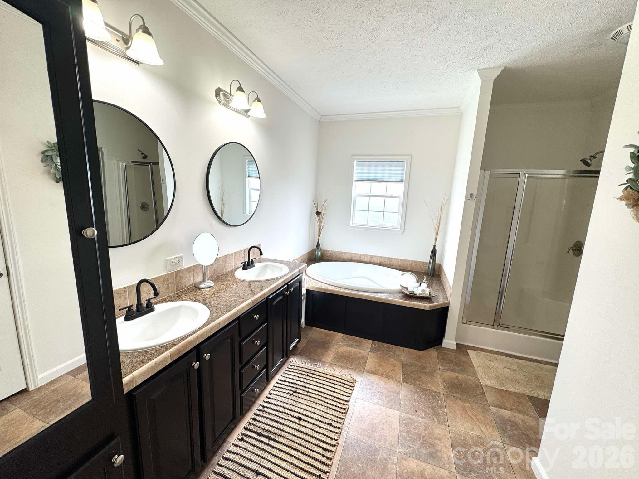 49428 Quail Trail Road Norwood, NC 28128 - Photo 8 of 13 a bathroom with a double vanity sink and a mirror