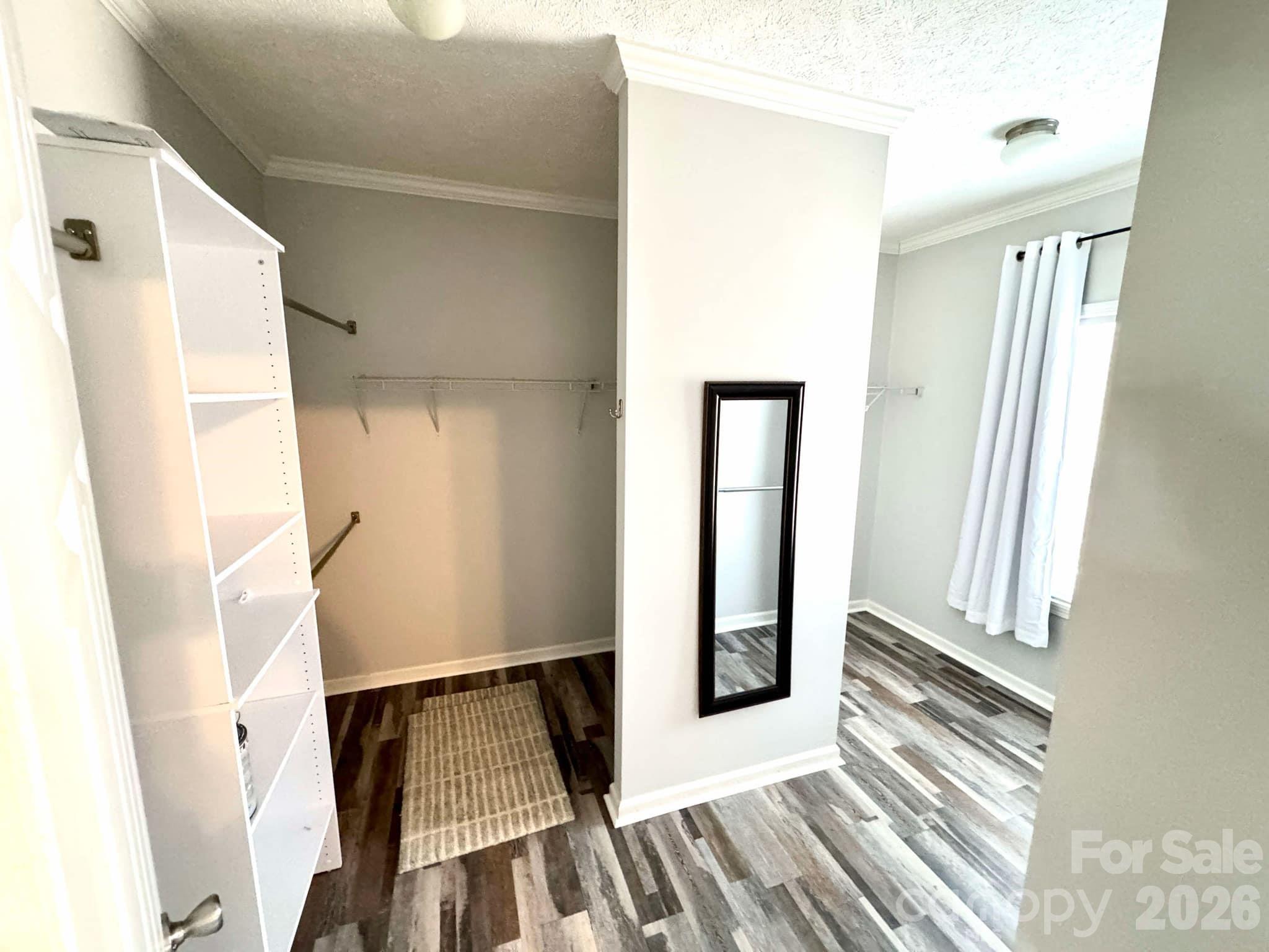 49428 Quail Trail Road Norwood, NC 28128 - Photo 10 of 13 a view of a hallway with wooden floor and staircase