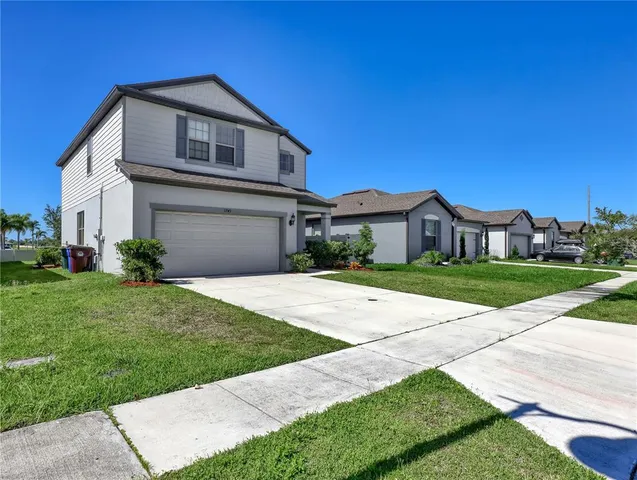 a front view of a house with a yard and garage