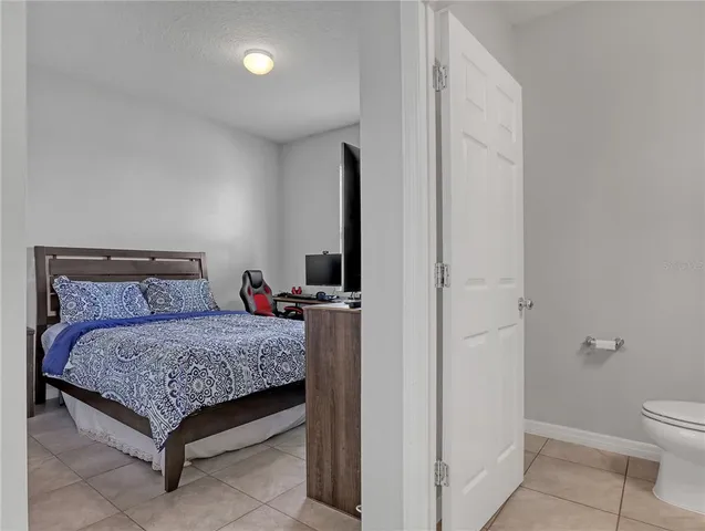 a bedroom with a bed and a table