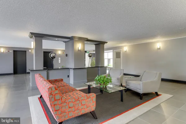a living room with furniture and a mirror