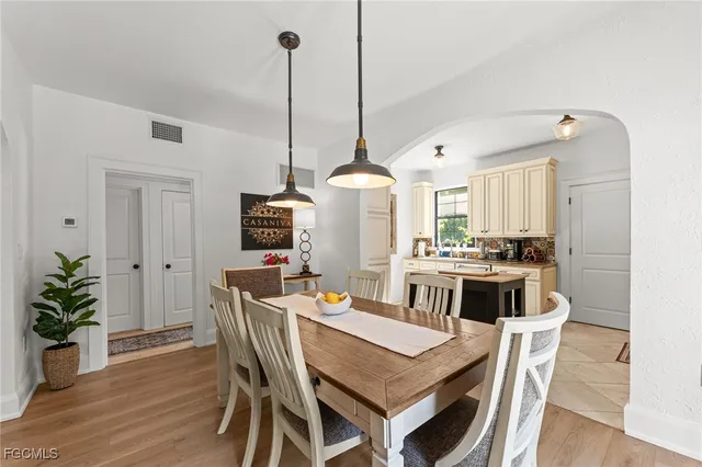 a dining room with furniture and wooden floor