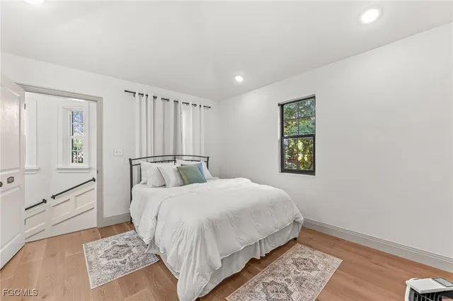 a bedroom with a large bed and a window