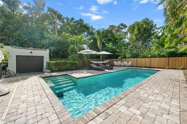 a view of a backyard with sitting area