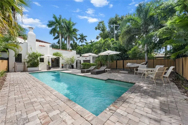 a view of a swimming pool with chairs in patio