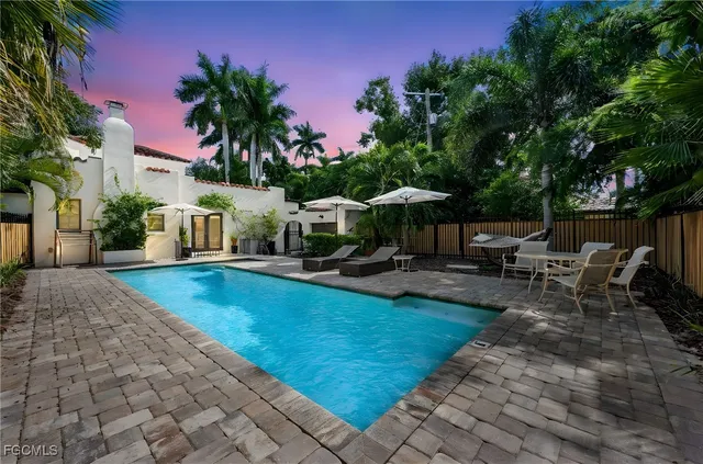 a view of a backyard with sitting area
