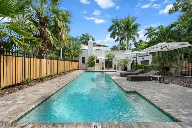a view of a backyard with a small cabin and deck