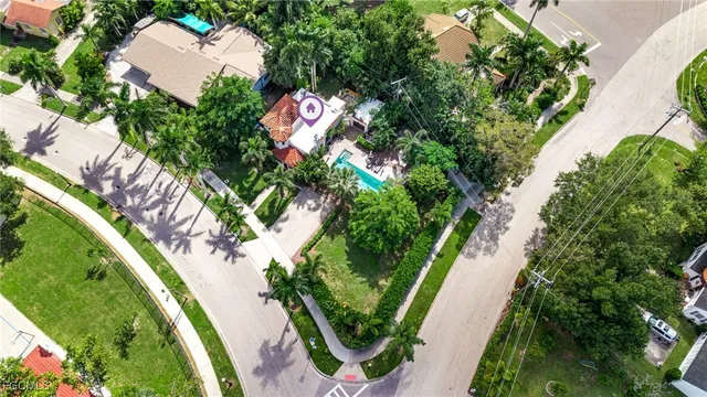 an aerial view of a house with a yard and lake view