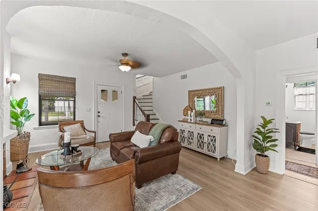 a living room with furniture and a potted plant