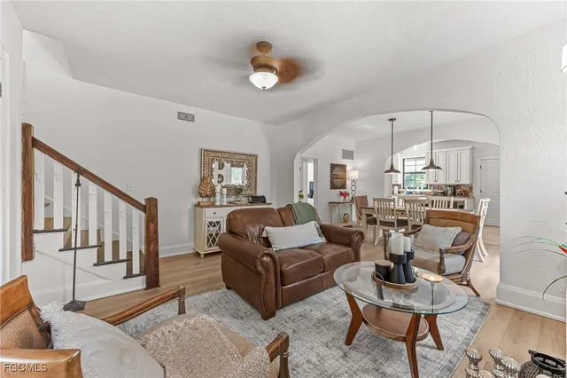 a living room with furniture and a chandelier