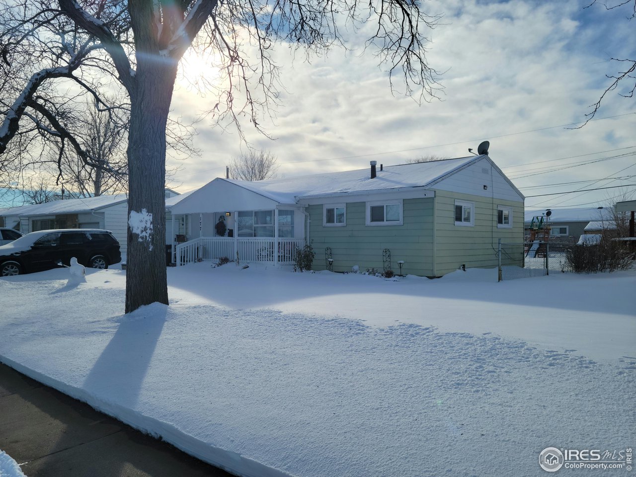 177 Delaware Drive Sterling, CO 80751 - Photo 2 of 13 a front view of a house with a yard and garage