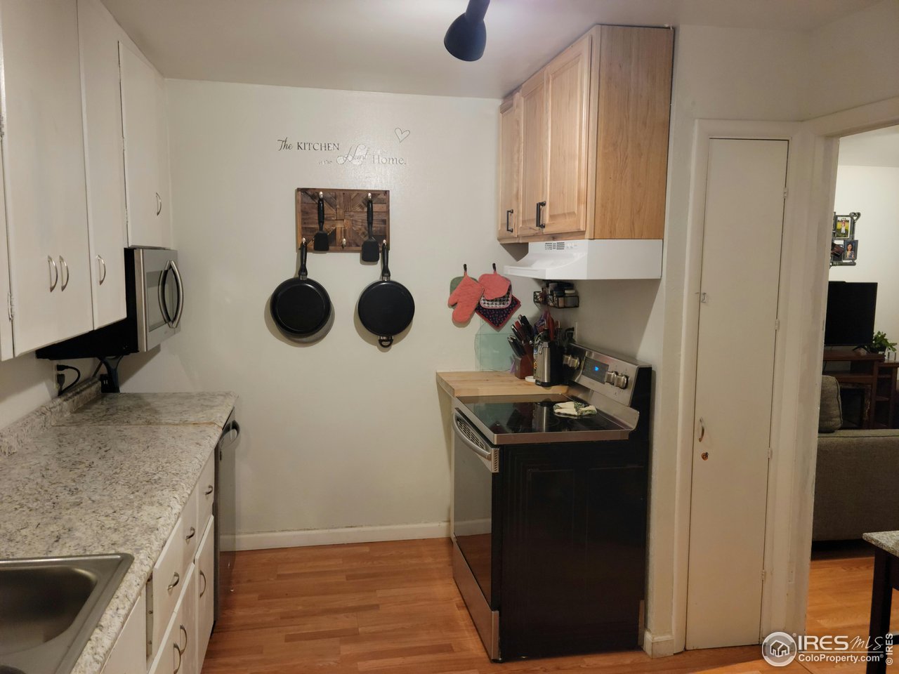 177 Delaware Drive Sterling, CO 80751 - Photo 4 of 13 a kitchen with a stove and a refrigerator