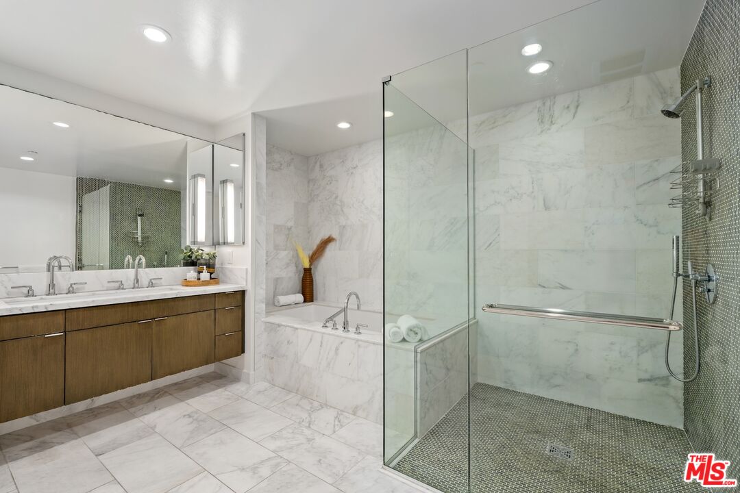1705 Ocean Avenue, Unit 206 Santa Monica, CA 90401 - Photo 18 of 26 a bathroom with a tub a sink shower and mirror