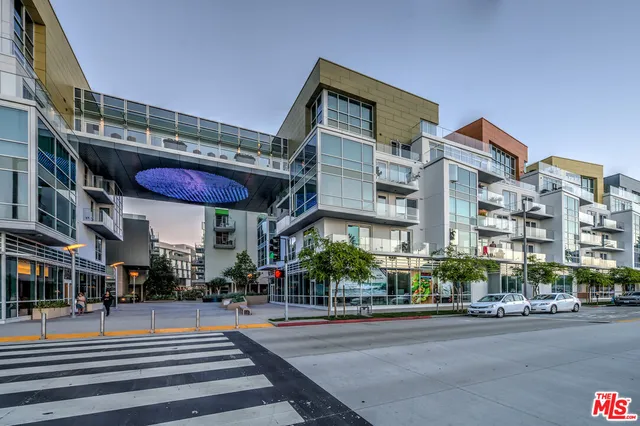 a living room with furniture a rug and a large window