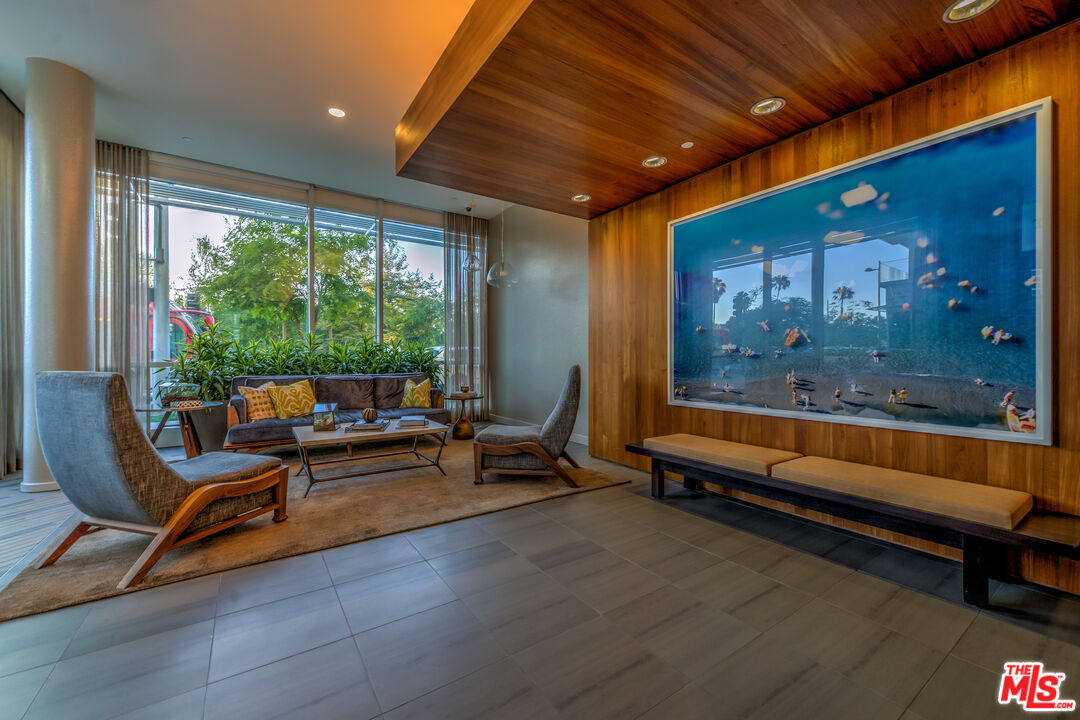 1705 Ocean Avenue, Unit 206 Santa Monica, CA 90401 - Photo 22 of 26 a living room with furniture a rug and a large window