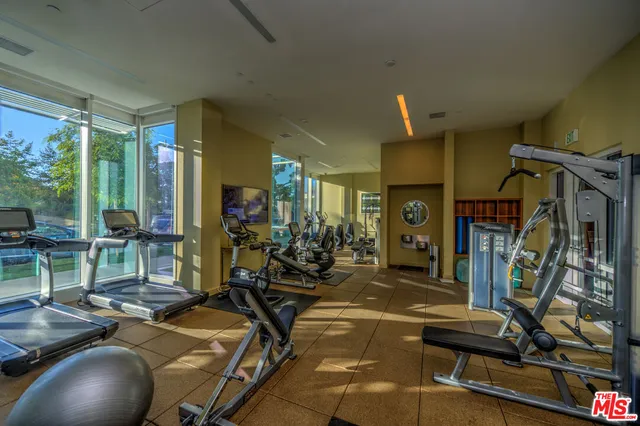 a view of roof deck with couches and potted plants
