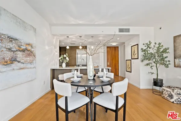 a dining room with furniture and wooden floor