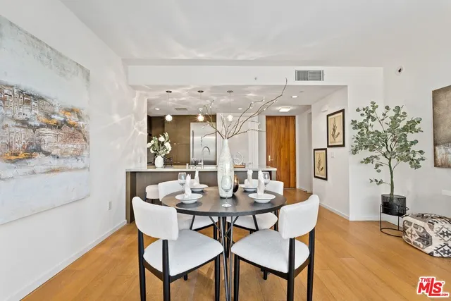 a dining room with furniture and wooden floor