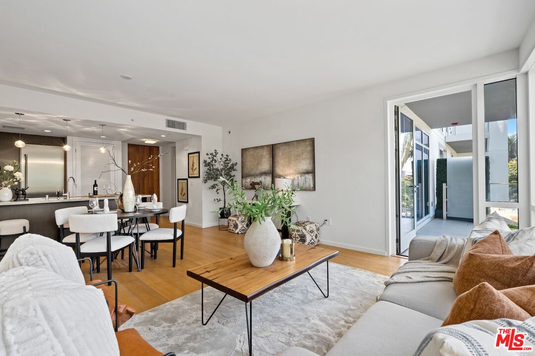 1705 Ocean Avenue, Unit 206 Santa Monica, CA 90401 - Photo 4 of 26 a living room with furniture potted plant and a table