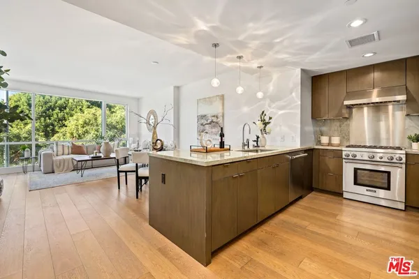 a kitchen with stainless steel appliances granite countertop a stove and a sink