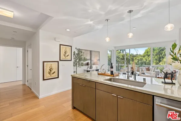 a kitchen with a sink appliances and a counter top space