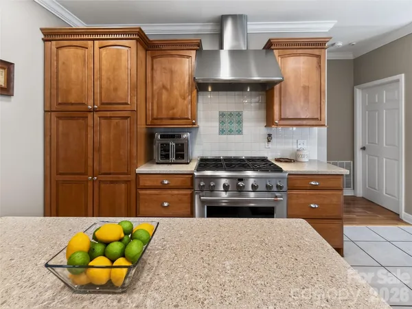 a kitchen with stainless steel appliances granite countertop a refrigerator and a stove