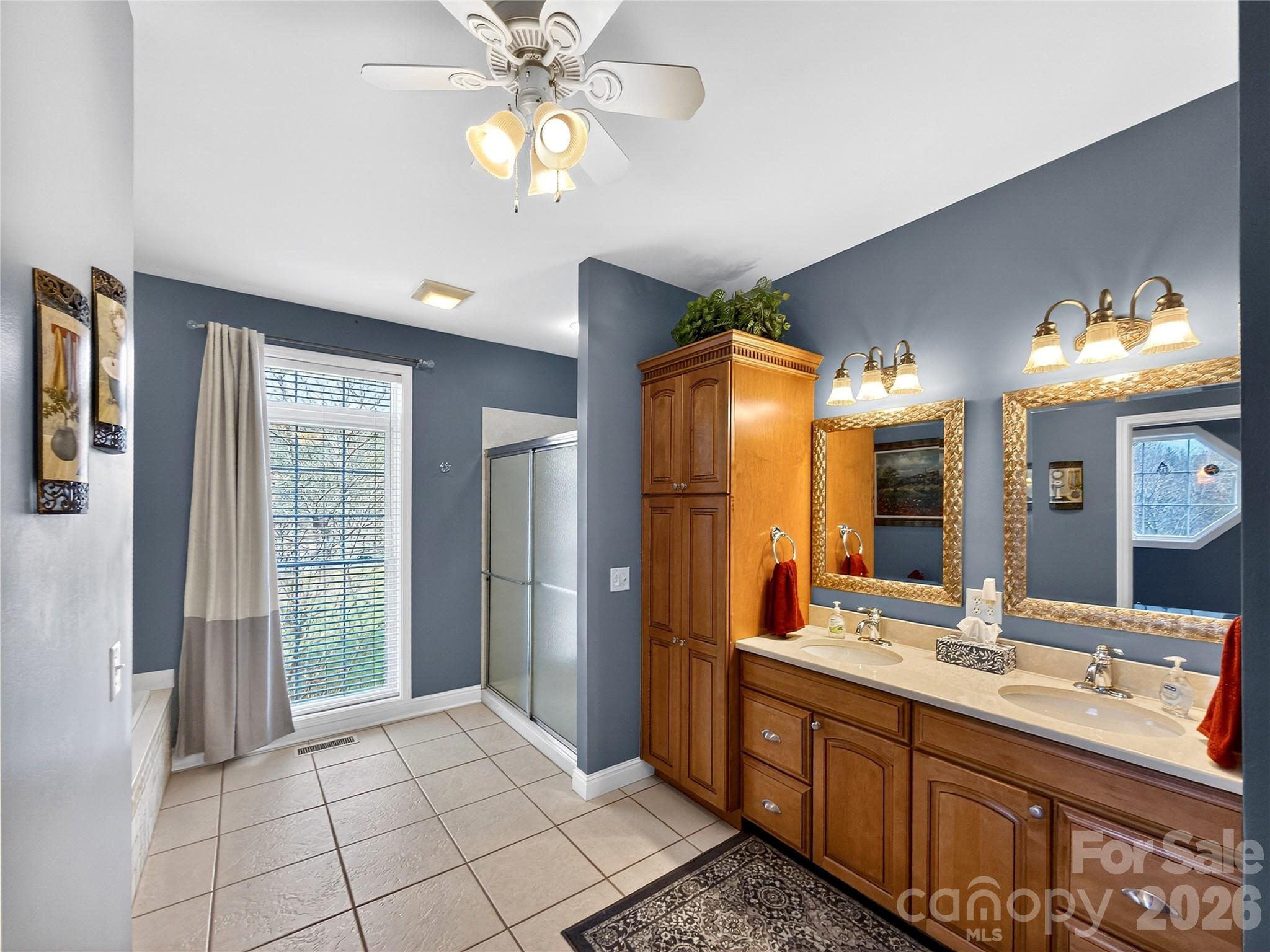 3275 Hanging Rock Road Spruce Pine, NC 28777 - Photo 15 of 48 a bathroom with a double vanity sink a mirror and a shower