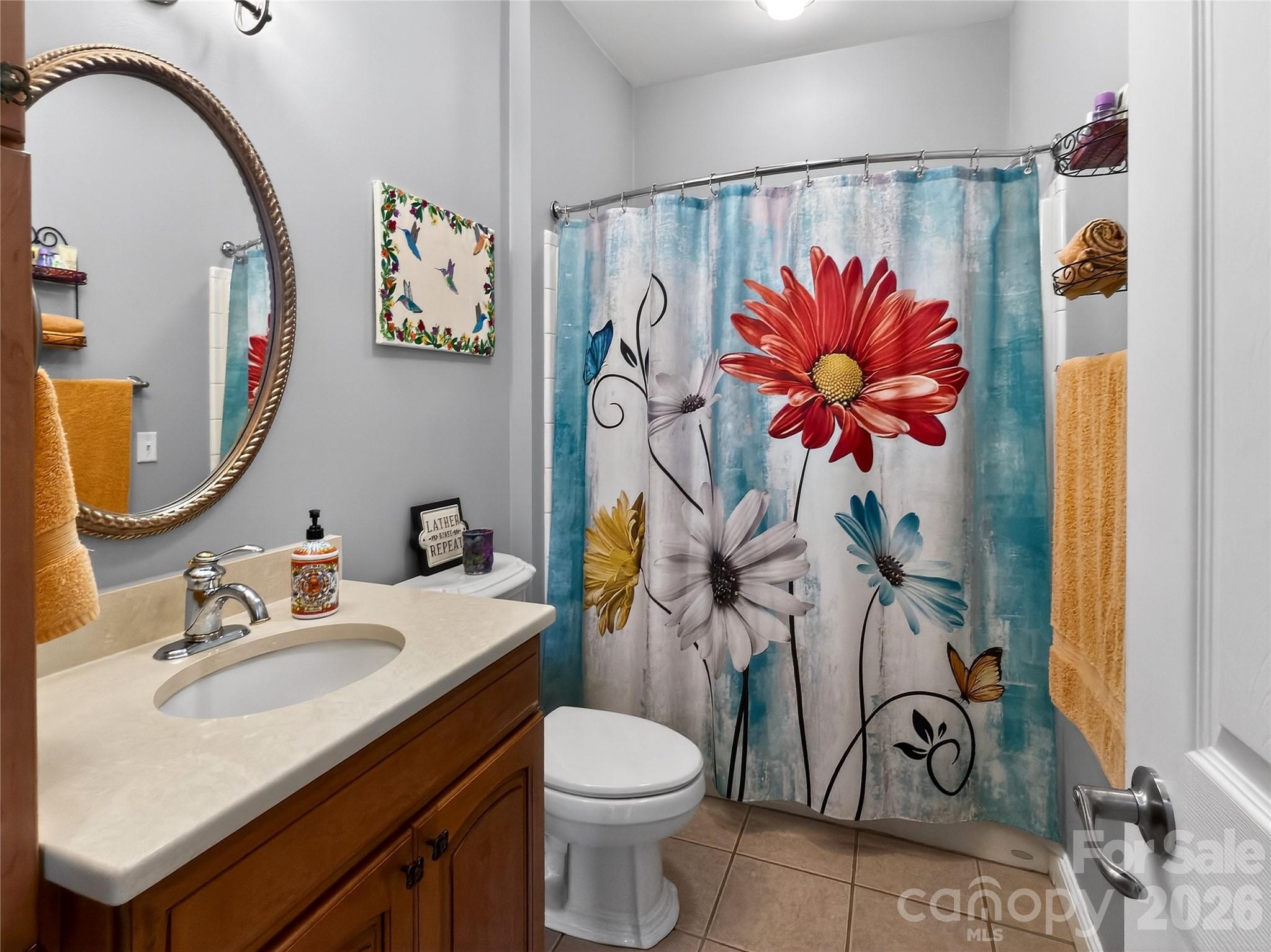 3275 Hanging Rock Road Spruce Pine, NC 28777 - Photo 20 of 48 a bathroom with a sink toilet and shower curtain