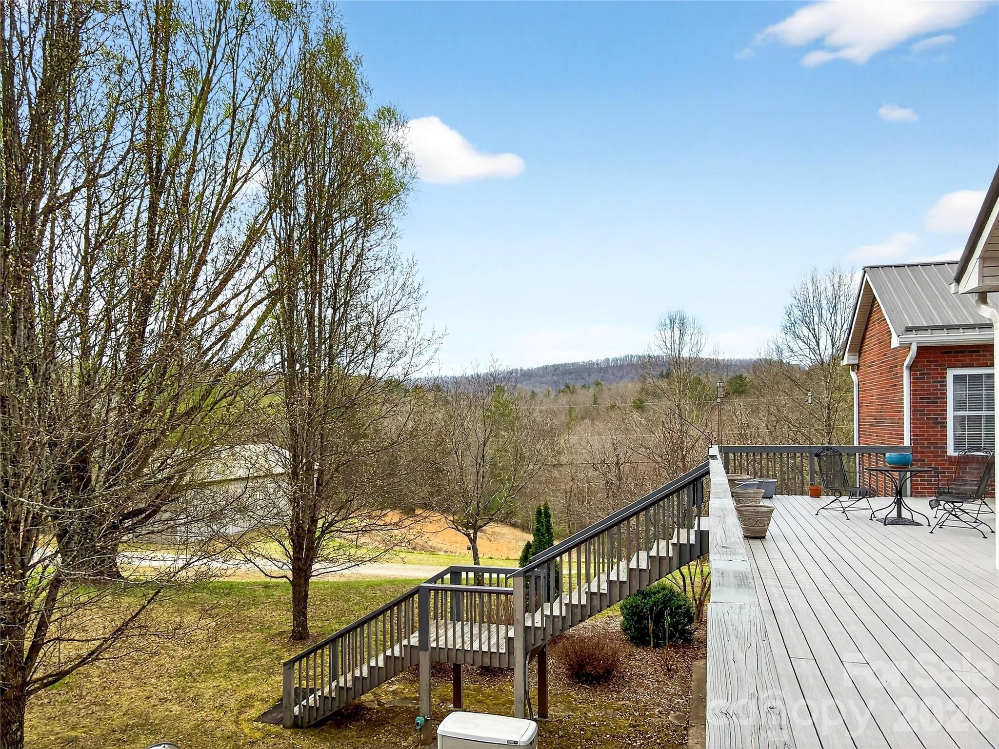 3275 Hanging Rock Road Spruce Pine, NC 28777 - Photo 24 of 48 a view of a balcony with two chairs and a table