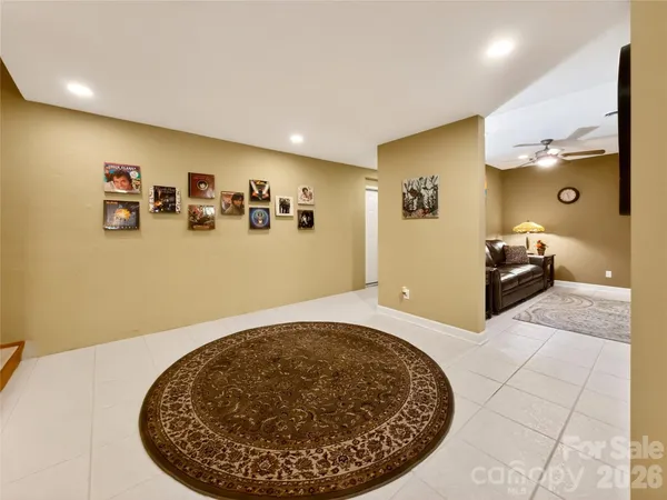 a living room with furniture a rug and a lamp