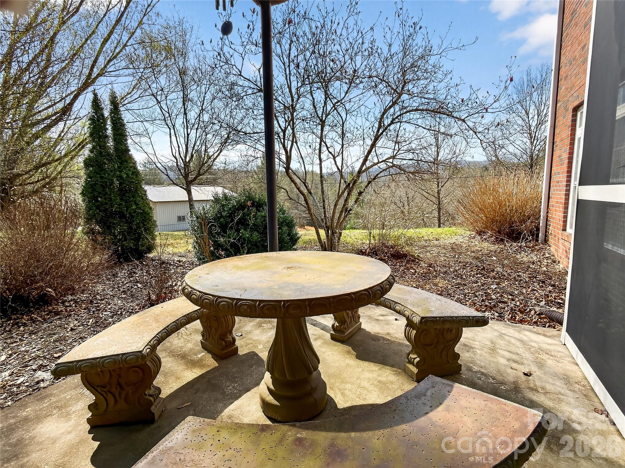 3275 Hanging Rock Road Spruce Pine, NC 28777 - Photo 41 of 48 a view of a backyard with table and chairs
