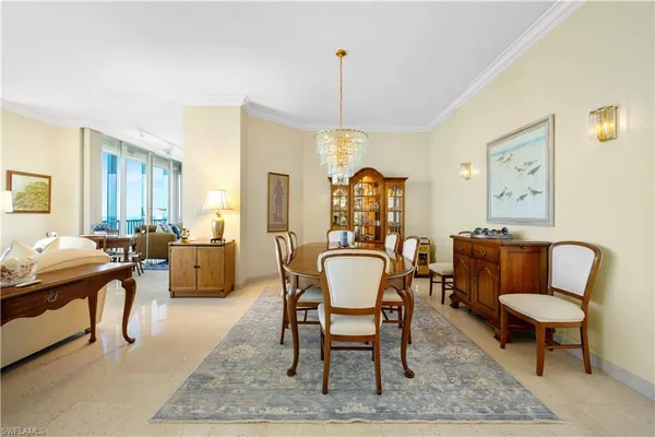 a dining room with furniture a rug and wooden floor