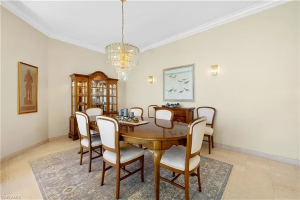 a view of a dining room with furniture and chandelier