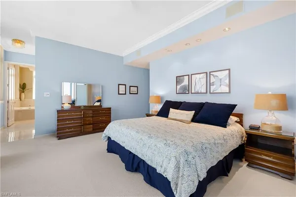 a bedroom with a bed and dresser