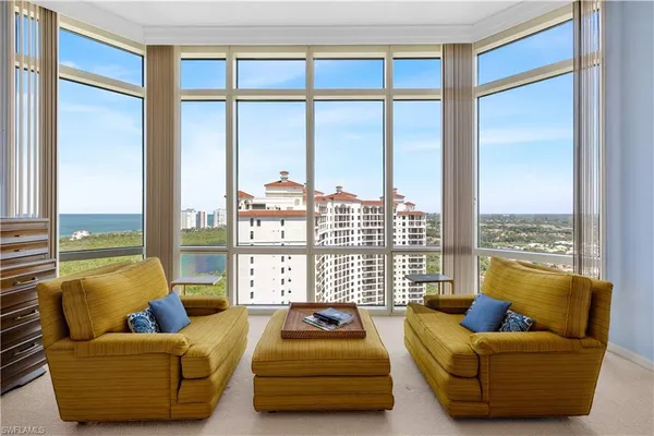 a bedroom with furniture and a large window