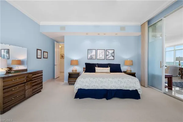 a spacious bedroom with a bed and dresser