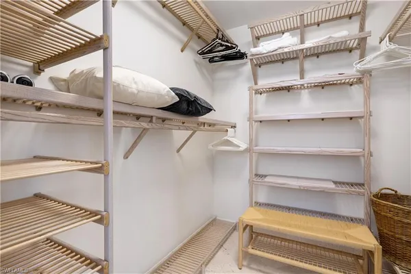 a view of walk in closet with empty racks