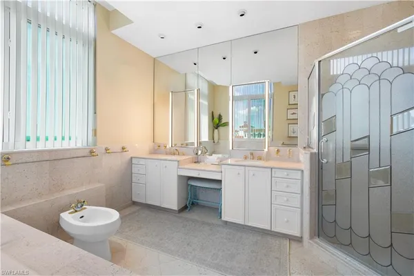 a bathroom with a double vanity sink toilet and shower