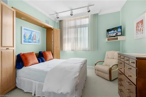 a bedroom with furniture and a window