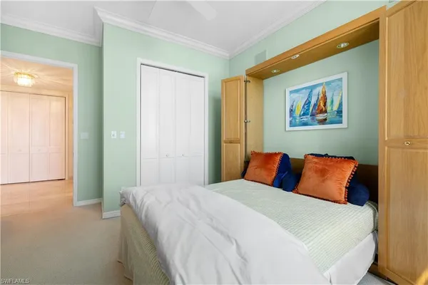 a bedroom with a bed and a painting on the wall