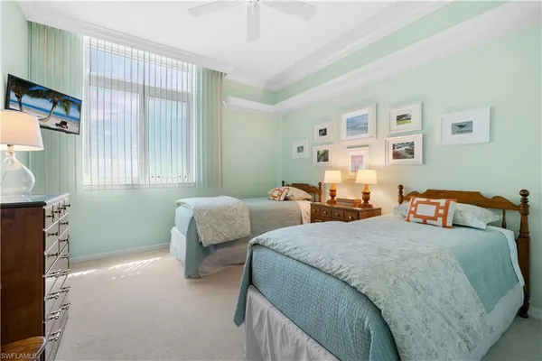 a bedroom with two beds and a window