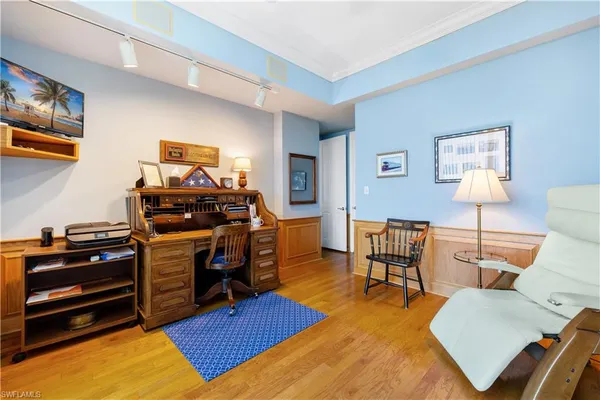 a bedroom with furniture and a wooden floor