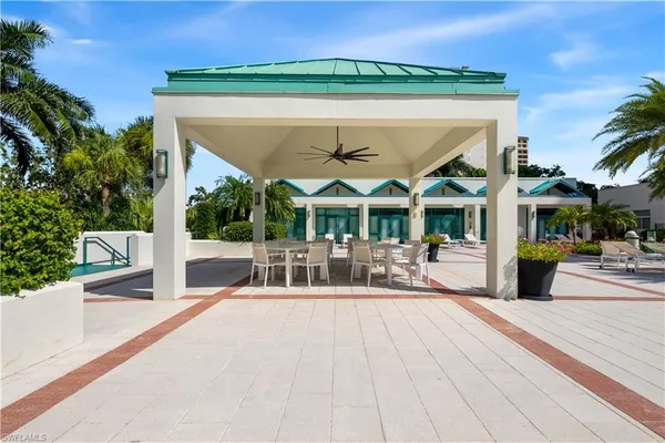 a view of a patio with a table and chairs under an umbrella with wooden floor