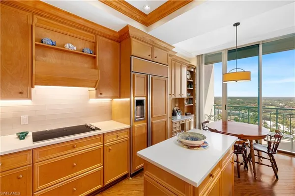 a kitchen with a stove a sink and a refrigerator
