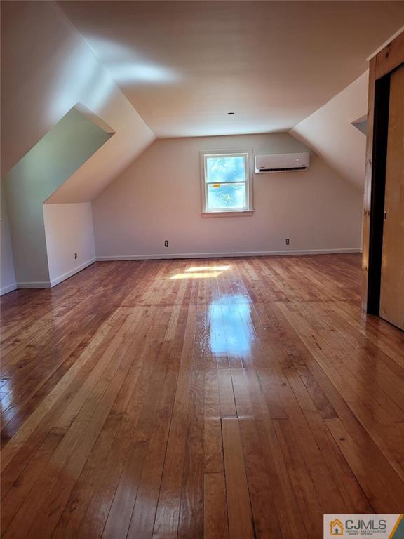 9 Carpender Road New Brunswick, NJ 08901 - Photo 9 of 15 an empty room with wooden floor and windows