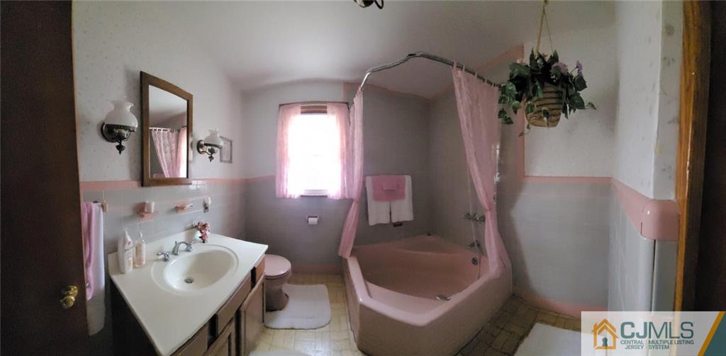 9 Carpender Road New Brunswick, NJ 08901 - Photo 10 of 15 a bathroom with a sink toilet and shower