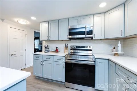 a kitchen with cabinets stainless steel appliances and sink
