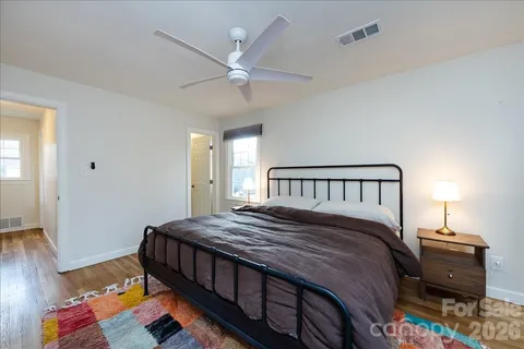 a bed sitting in a bedroom next to a window