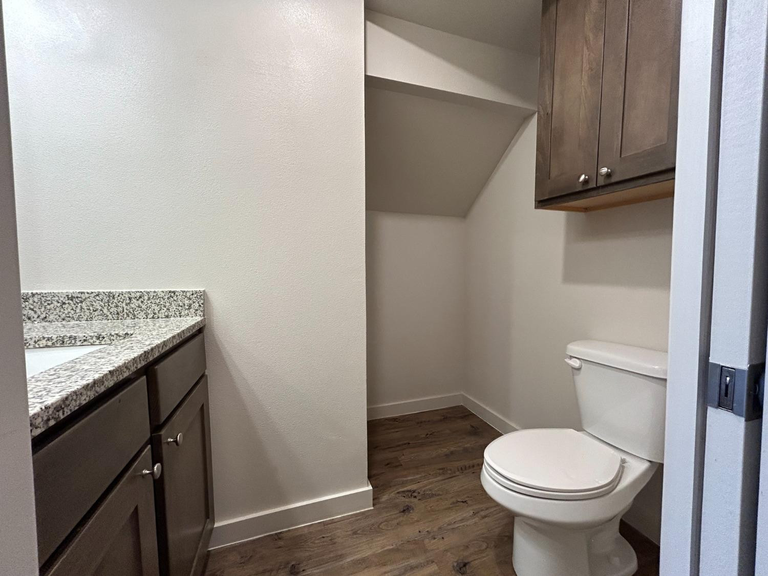 2603 135th Street Lubbock, TX 79423 - Photo 5 of 12 a bathroom with a granite countertop toilet and a sink